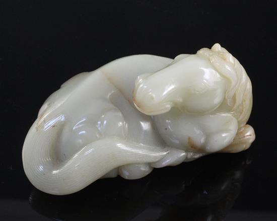 A Chinese celadon and brown jade figure of a recumbent horse, 20th century, 9.5cm